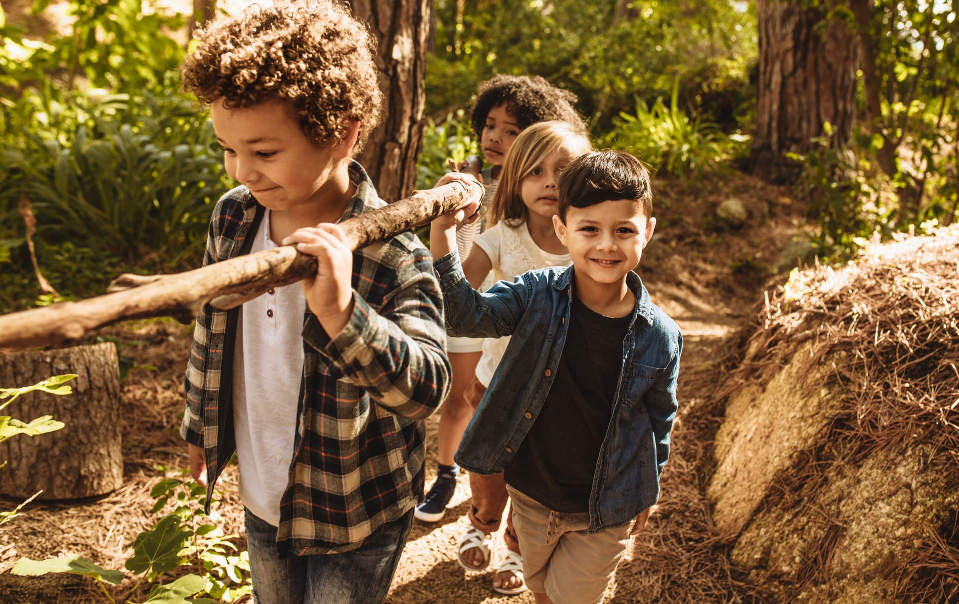 Child playing outdoors in a sensory-rich environment